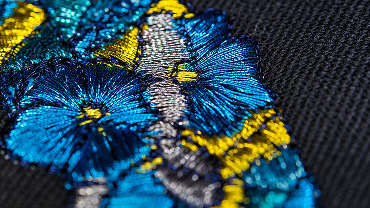 blue and gold metallic thread embroidery of petals